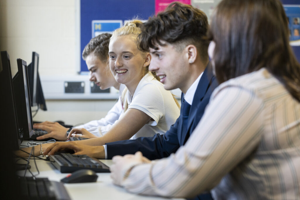 Four students using computers